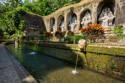 Arch bridge over canal against building