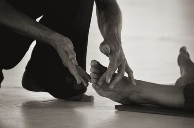 Low section of people on wooden floor