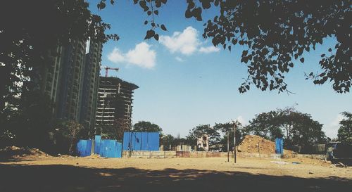 Buildings against cloudy sky