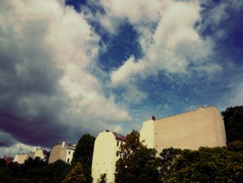 Low angle view of building against cloudy sky