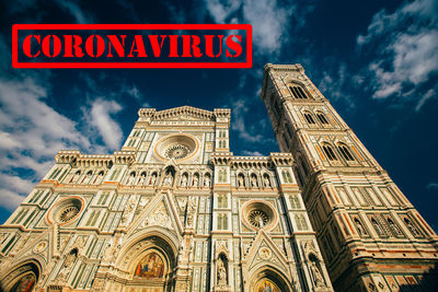 Low angle view of text on building against sky