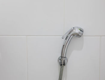 Close-up of faucet against wall at home