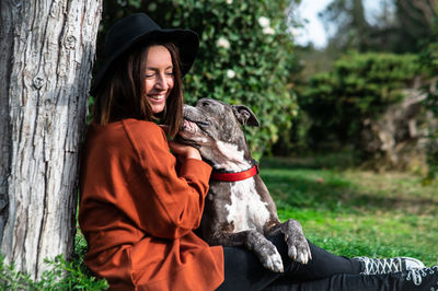 Woman playing with pet dog at park