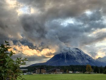 Scenic view of mountains against cloudy sky