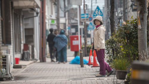 Rear view of woman walking in city