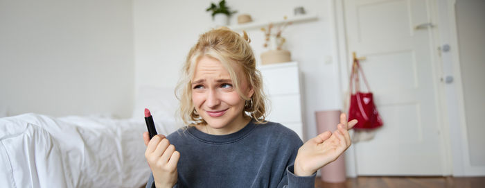 Portrait of young woman holding knife