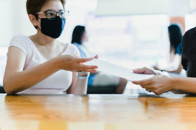 Business successful concept businesswoman giving contract paper to partner for signing.