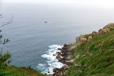 High angle view of rocks by sea against sky