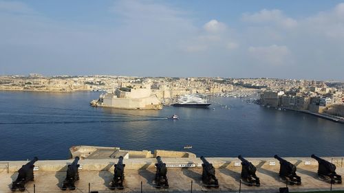 Boats moored in calm sea against sky