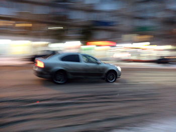 Blurred motion of car on road in city at night