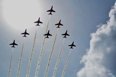 Low angle view of airshow against sky