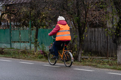 Man riding bicycle on road