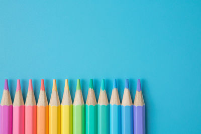 Close-up of colored pencils against white background