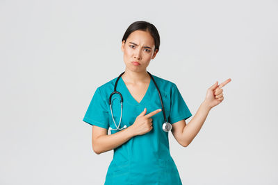 Young woman standing against white background