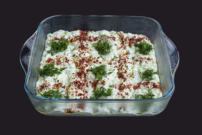 High angle view of vegetables in bowl against black background