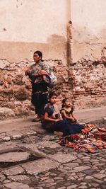 People sitting on wall