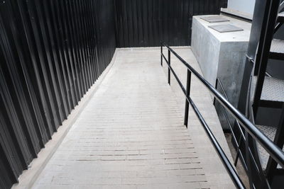 Concrete ramp way with metal handrail for support wheelchair