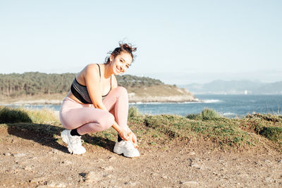 Young woman sitting on beach