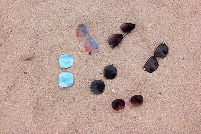 High angle view of sunglasses on sand