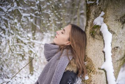 Side view of woman looking at snow