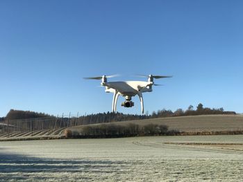 Helicopter flying against clear blue sky