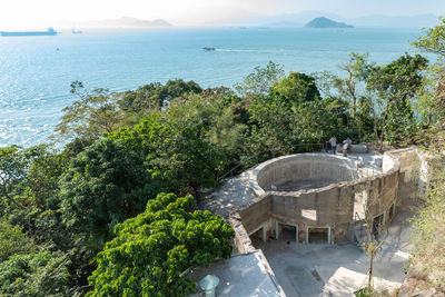 High angle view of sea and trees against sky