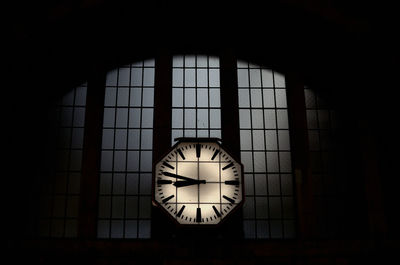 Low angle view of clock on window at railroad station