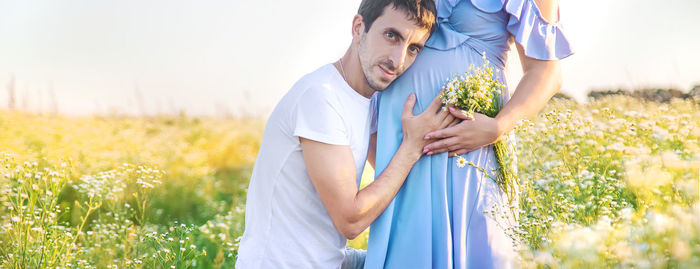 Man touching belly of pregnant woman