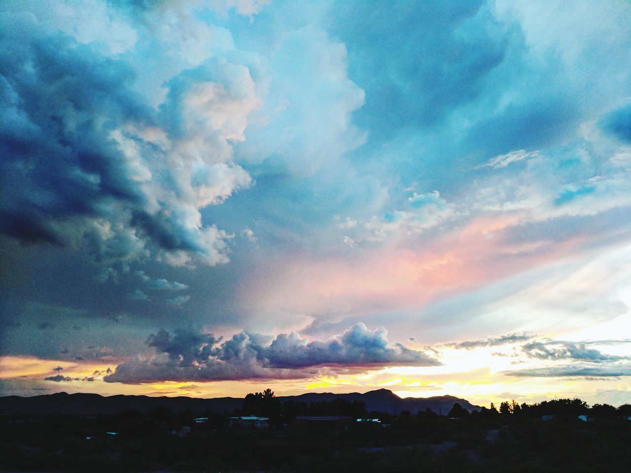 cloud - sky, sky, beauty in nature, scenics, atmospheric mood, nature, dramatic sky, tranquility, tranquil scene, cloudscape, silhouette, no people, weather, sunset, outdoors, storm cloud, day