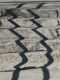 High angle view of tire tracks on sand