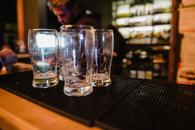 Close-up of beer glasses on table