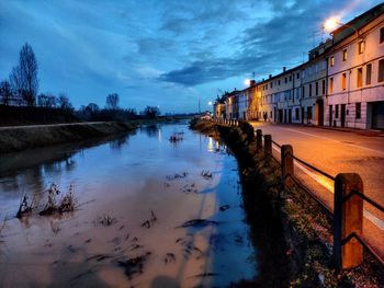 Scenic view of river against sky at sunset