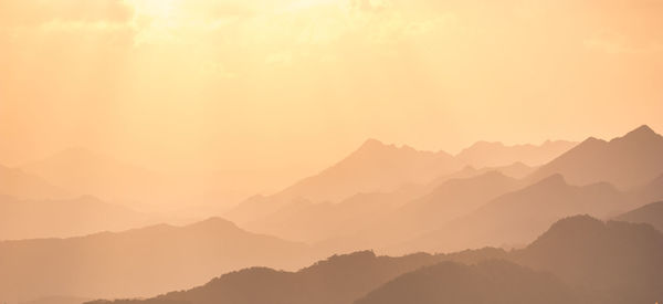 Scenic view of mountains against sky during sunset