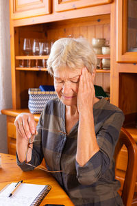 Young woman using mobile phone while sitting at home