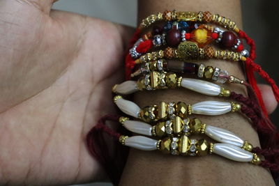 Close-up of hand holding painting rakhi rakshabandhan festival celebration