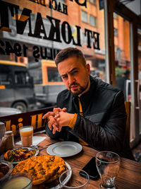 Portrait of senior man preparing food in restaurant