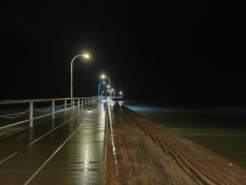 Illuminated street lights on footpath at night