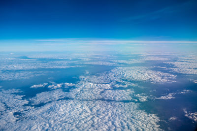 Beautiful blue cloudy sky on the top of the plane while traveling pass by.