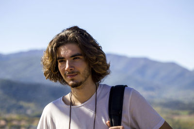 Male hiker looking away during sunny day
