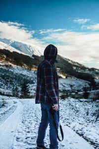 Full length of man standing on snow covered land