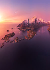 Aerial landscape of calm river and rocky formations located in hamnoy under sunset sky in evening
