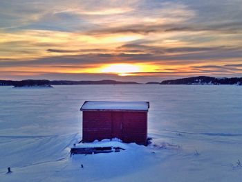 Snow covered landscape at sunset