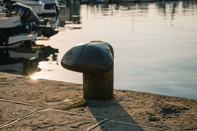 High angle view of iron post on pier at lake