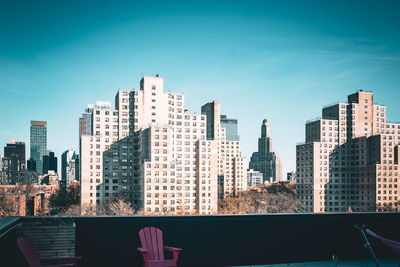 View of modern tall buildings and traditional apartment buildings seen from deck in brooklyn, ny