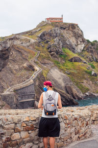 Rear view of woman walking on rock