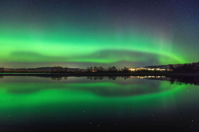 Scenic view of lake against sky at night