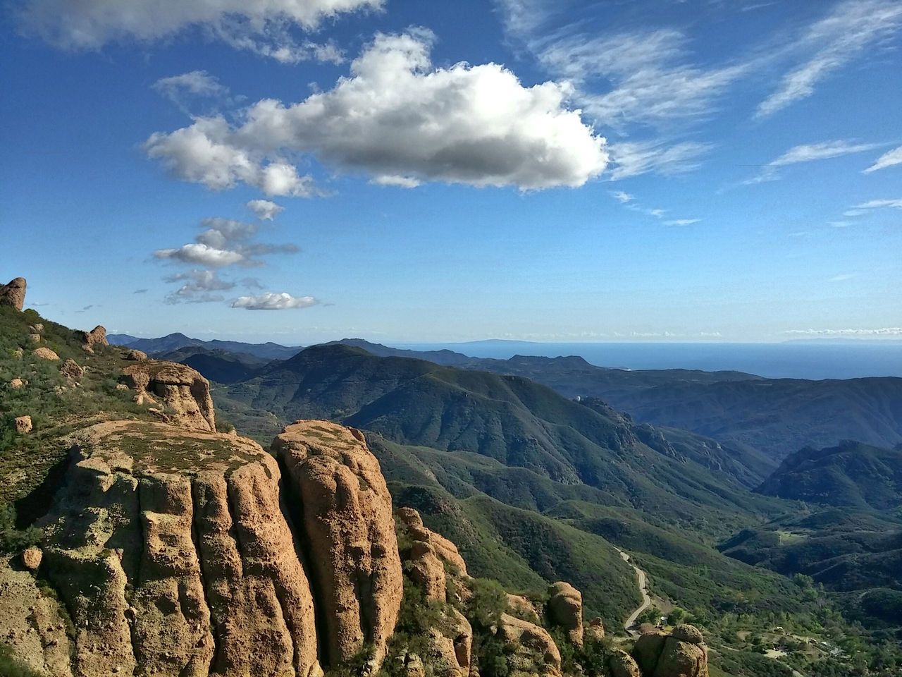 tranquil scene, scenics, tranquility, mountain, beauty in nature, landscape, sky, nature, geology, physical geography, rock formation, mountain range, non-urban scene, rock - object, idyllic, blue, high angle view, cloud, cloud - sky, remote