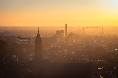 High angle view of buildings in city at sunset