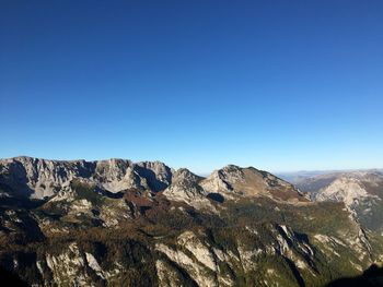 Scenic view of mountains against clear blue sky