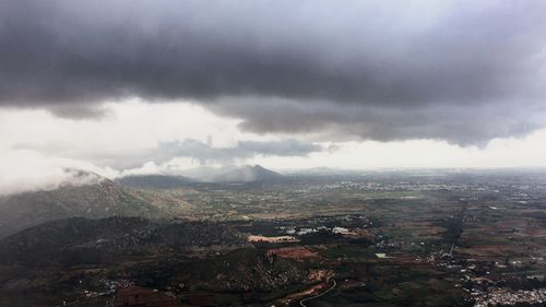 High angle view of cityscape against cloudy sky